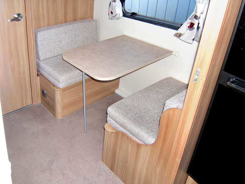 The fixed dinette area to the rear of the caravan.